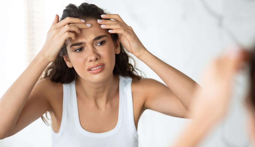 a woman looking at her face